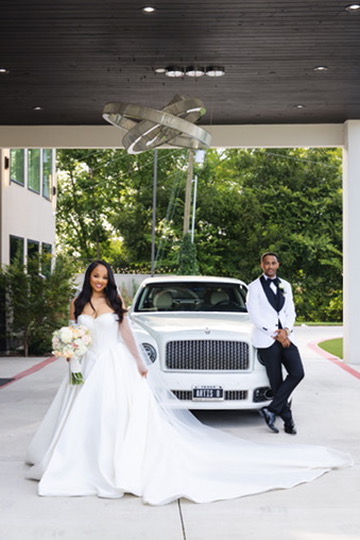 Wedding couple by classic car